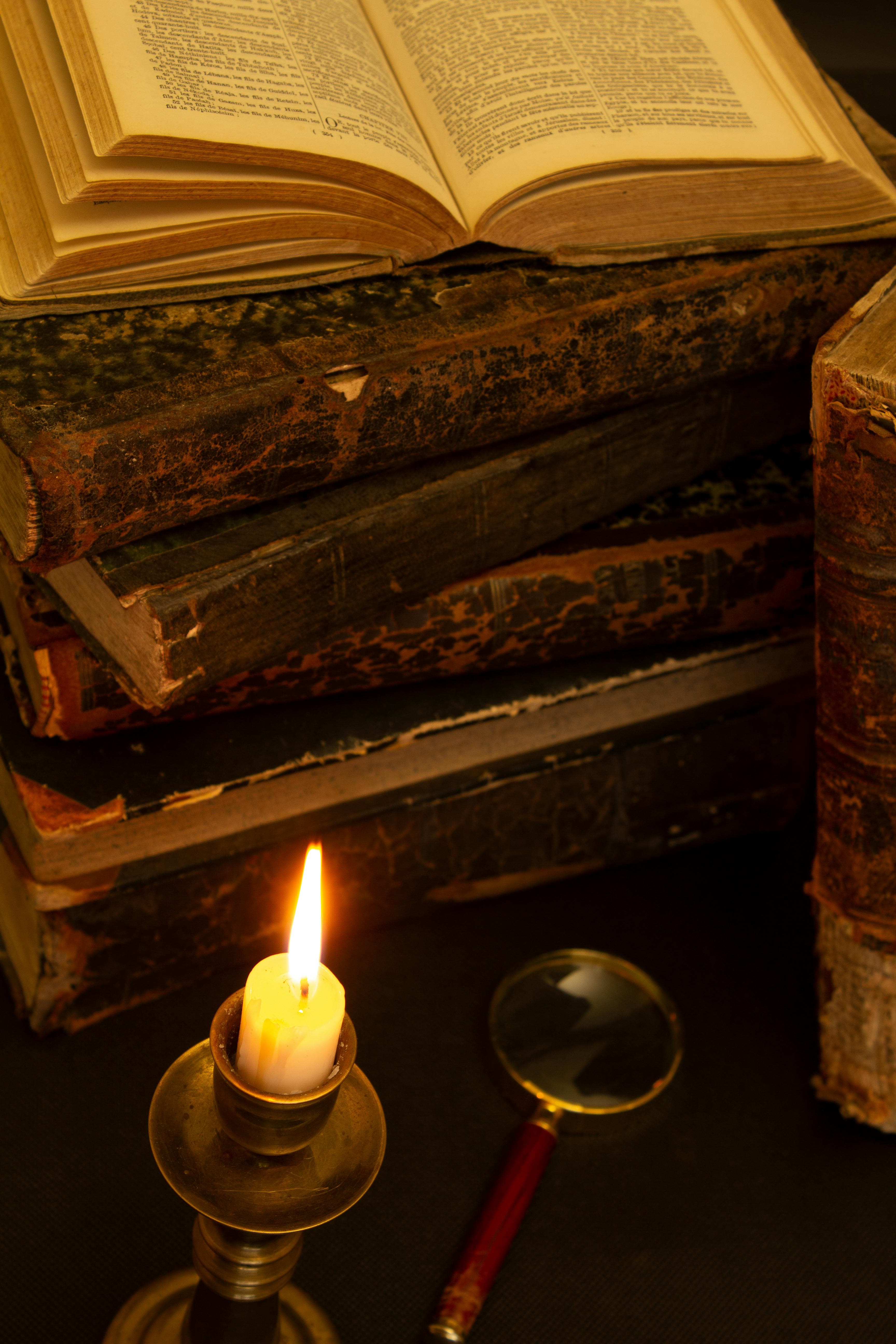 A candle beside an open book